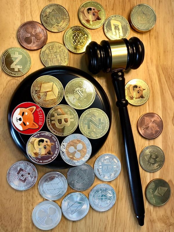 Crypto coins and a judge gavel on a wooden table