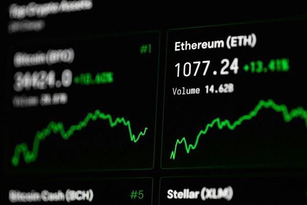 Crypto price tickers with green charts on a trading screen