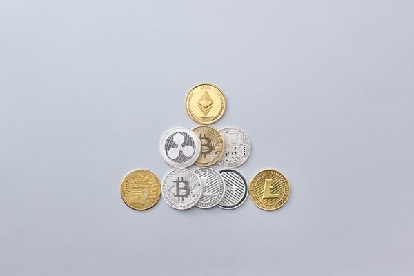 Pyramid of different crypto coins on a white background
