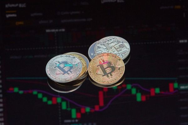 Crypto coins lying on a candlestick chart background