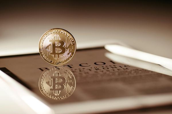 Bitcoin coin reflected on a glass surface