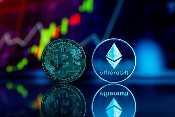 Bitcoin and Ethereum coins in front of glowing market charts