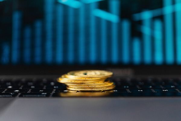 Coins in front of a glowing blue bar chart